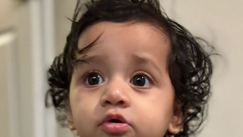 Kumar baby in teal muslin dress