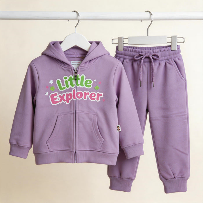 The lavender Little Explorer cotton zip hoodie and matching joggers on wooden hangers against a pale wall.