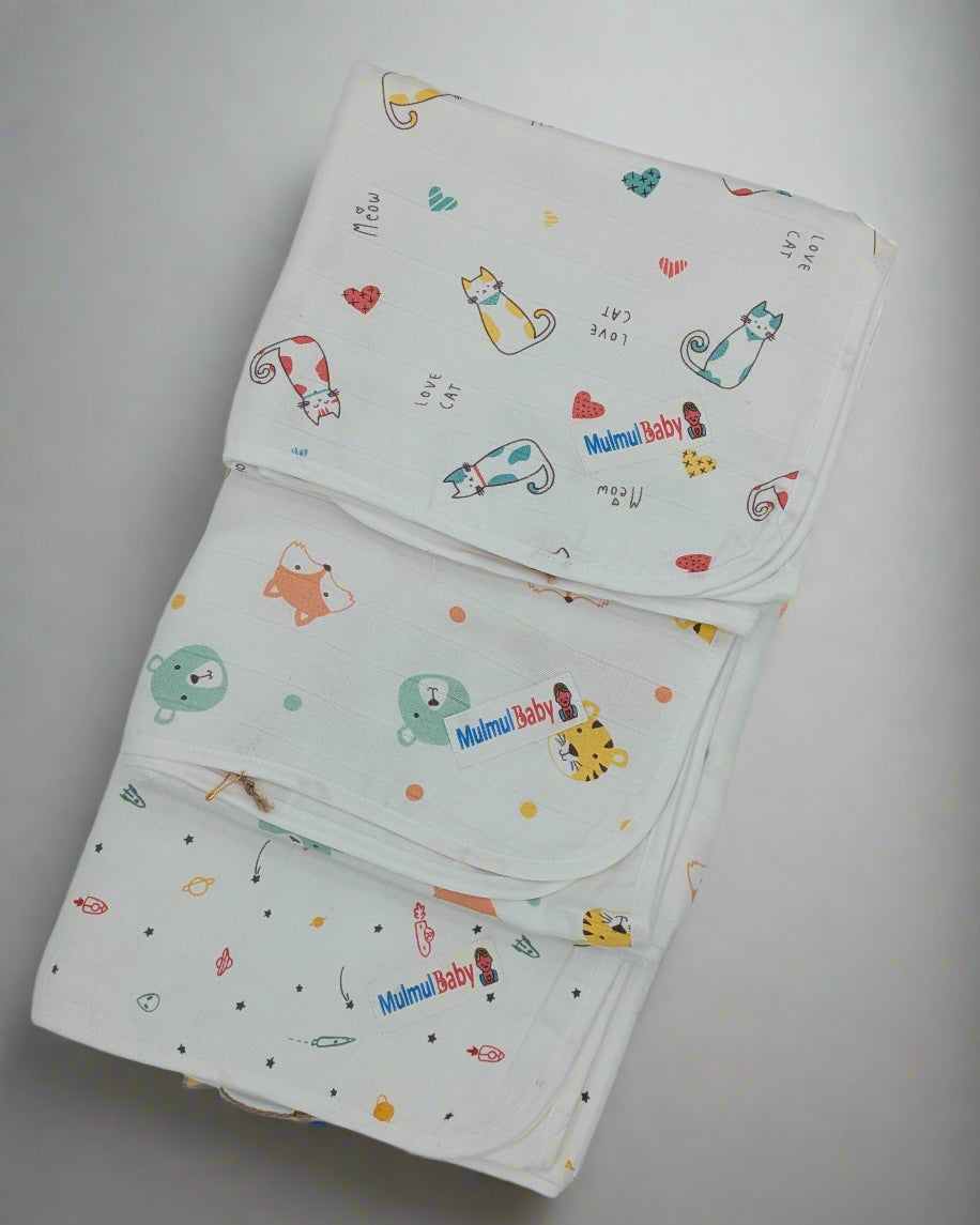 Organic muslin swaddle blankets in several animal prints — how many swaddles you need