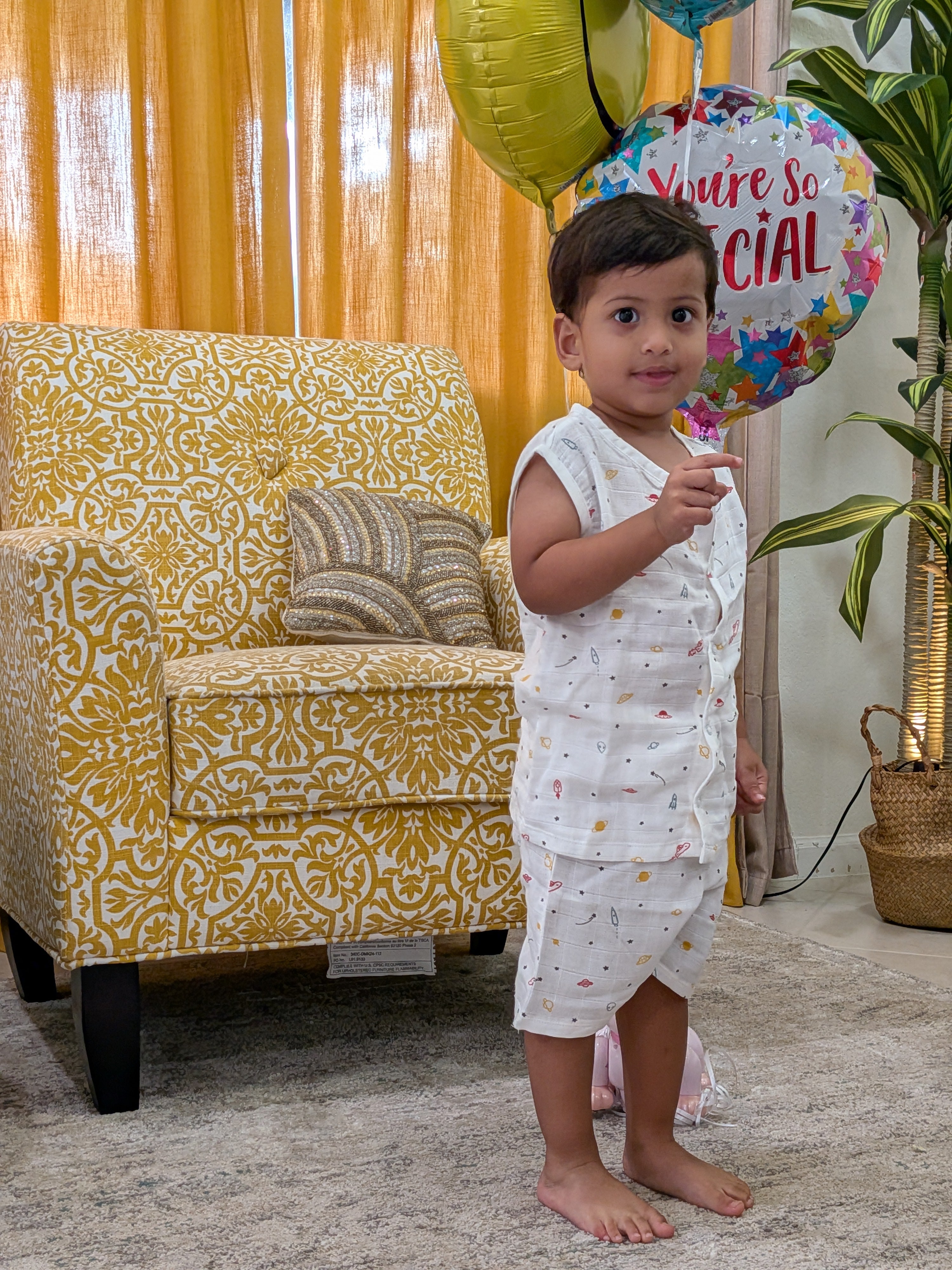 Toddler wearing MulmulBaby 2-piece matching sleeveless shirt and shorts set in organic muslin, space print