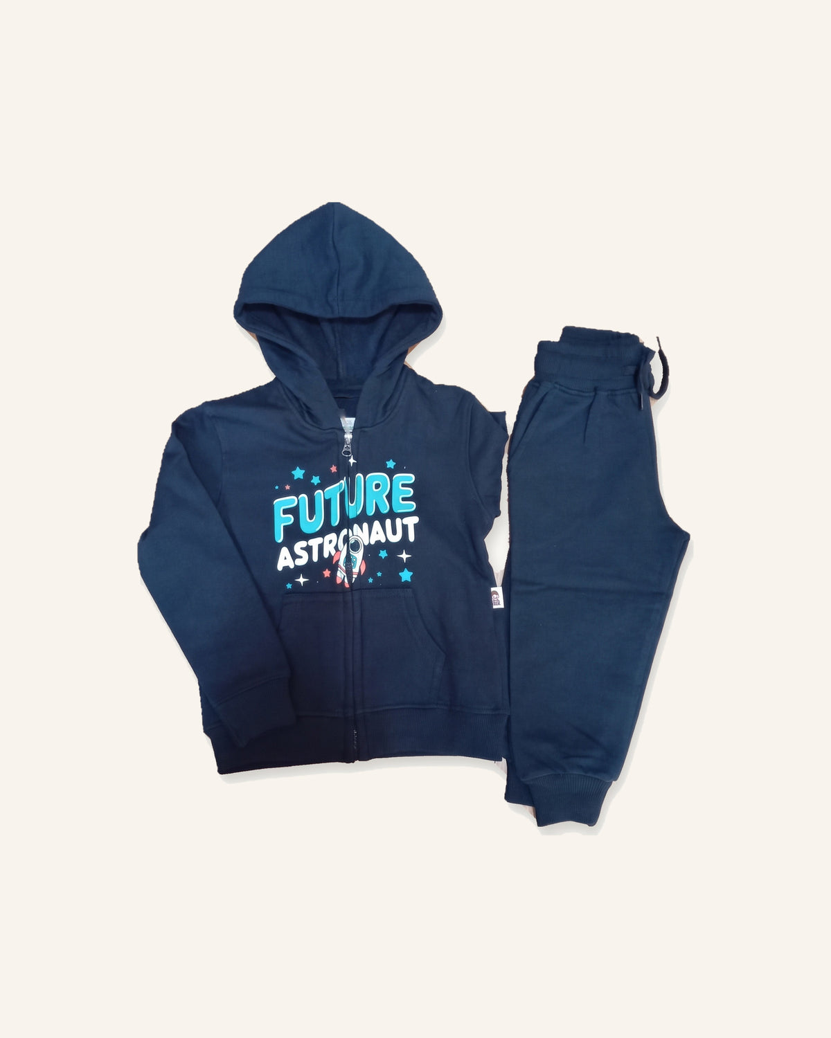The navy Future Astronaut cotton zip hoodie laid flat with the matching joggers beside it.