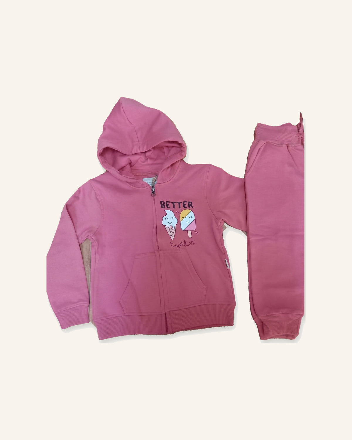 The rose Better Together cotton zip hoodie laid flat with the matching joggers beside it.