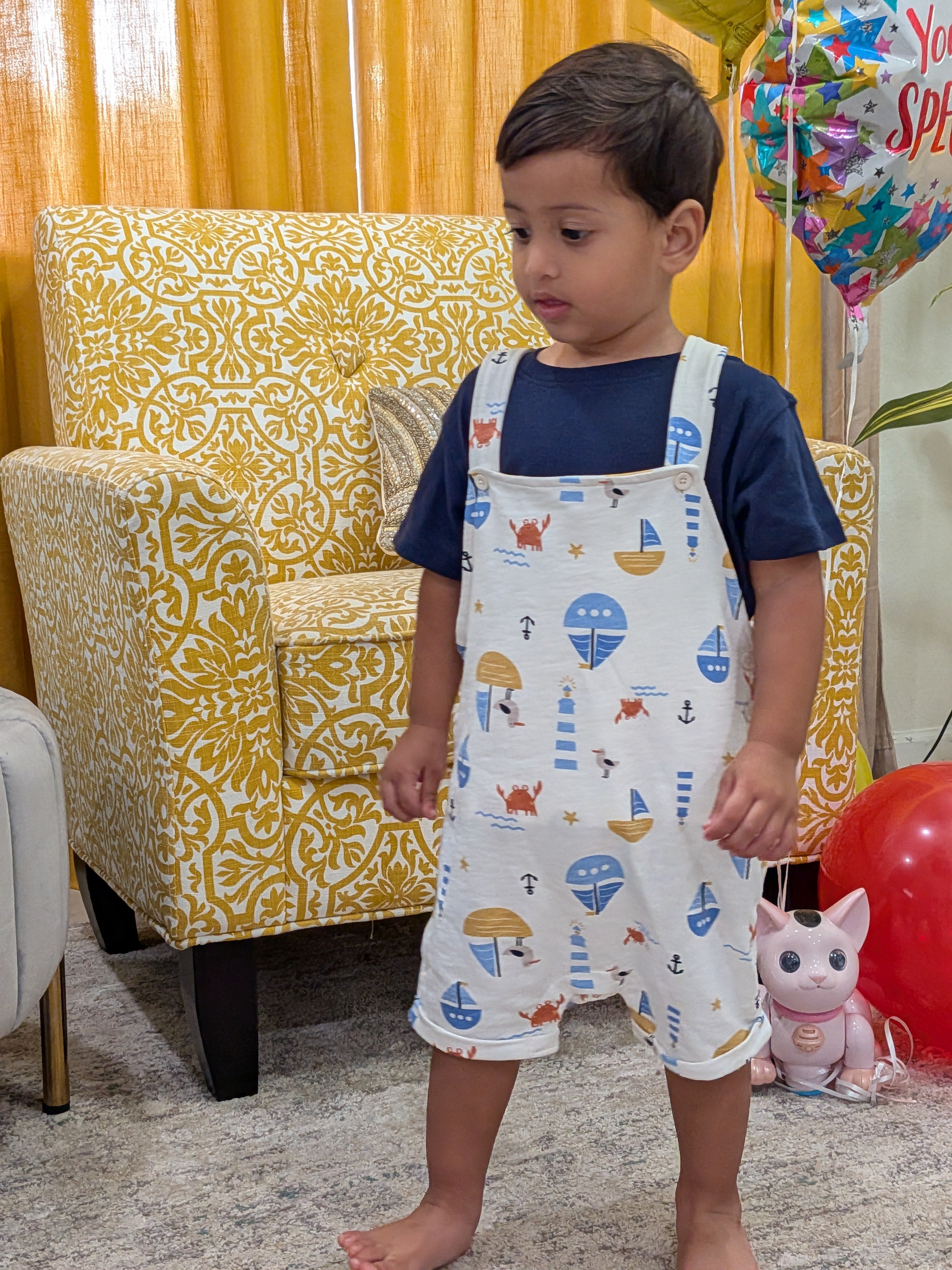 Toddler standing in MulmulBaby Nautica nautical-print dungaree overalls set
