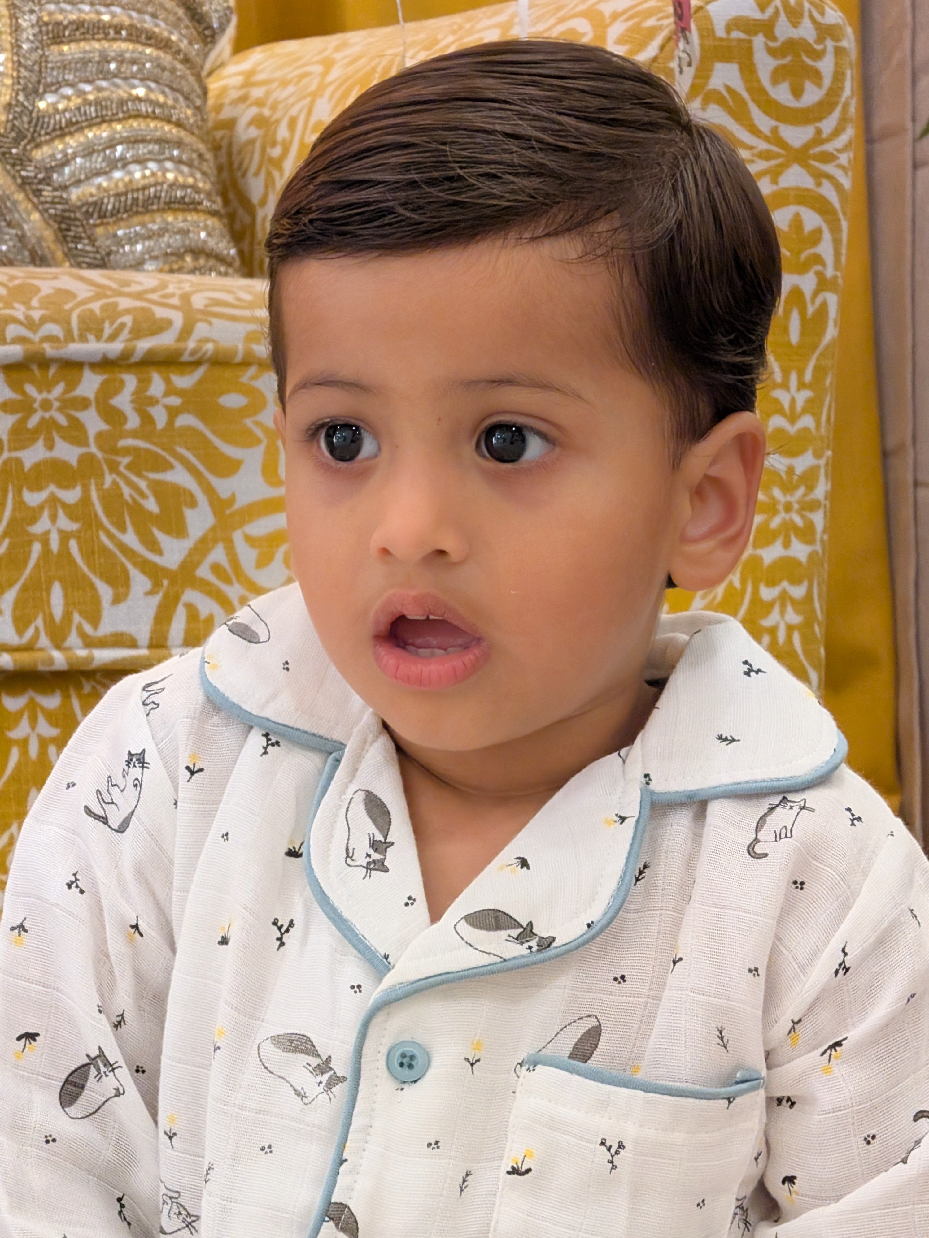 Toddler wearing MulmulBaby 2-piece organic muslin night suit with animal print and blue piping