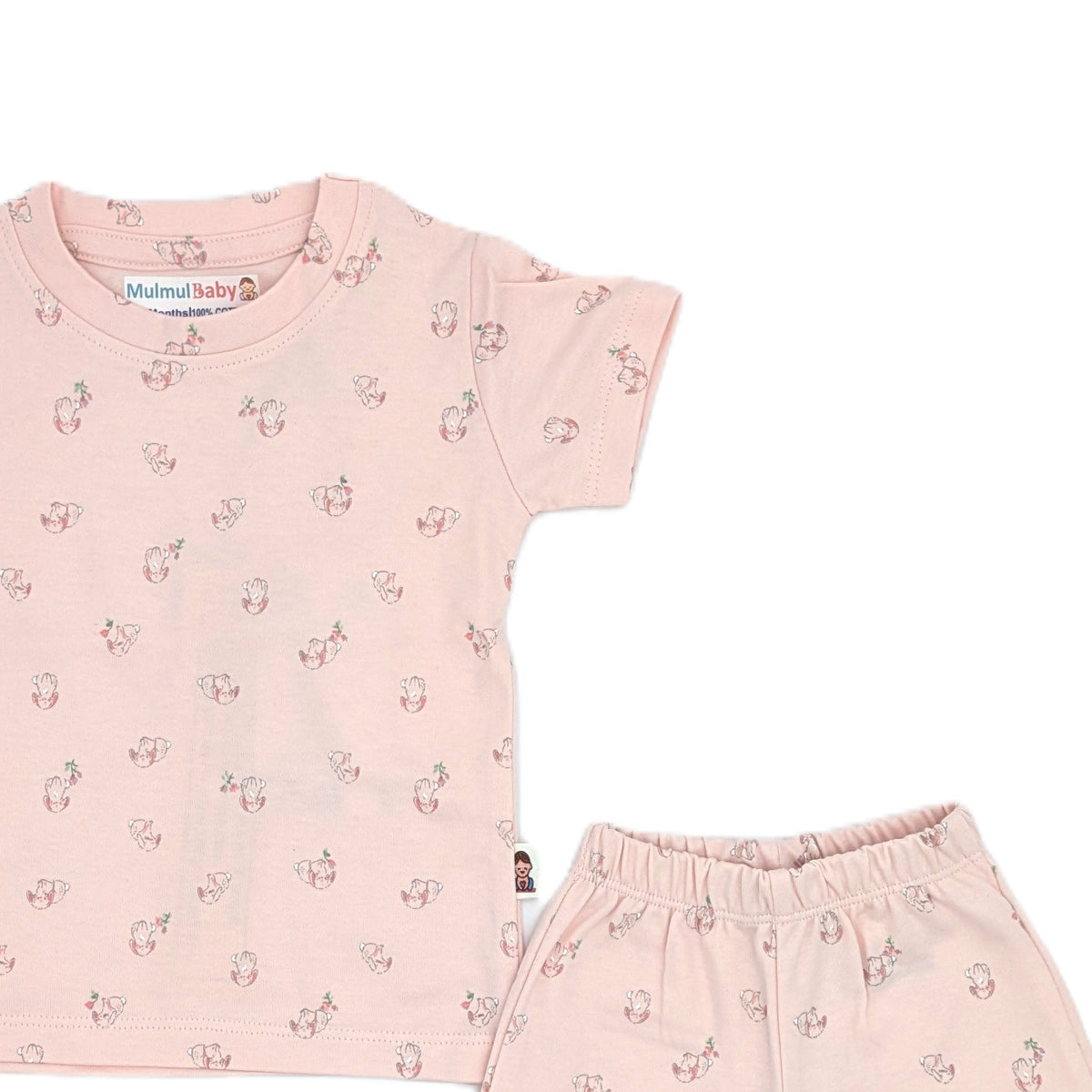 Close view of the blush pink puppy print showing the small puppies and blossom sprigs, the MulmulBaby neck label and the elastic waistband of the matching trousers.