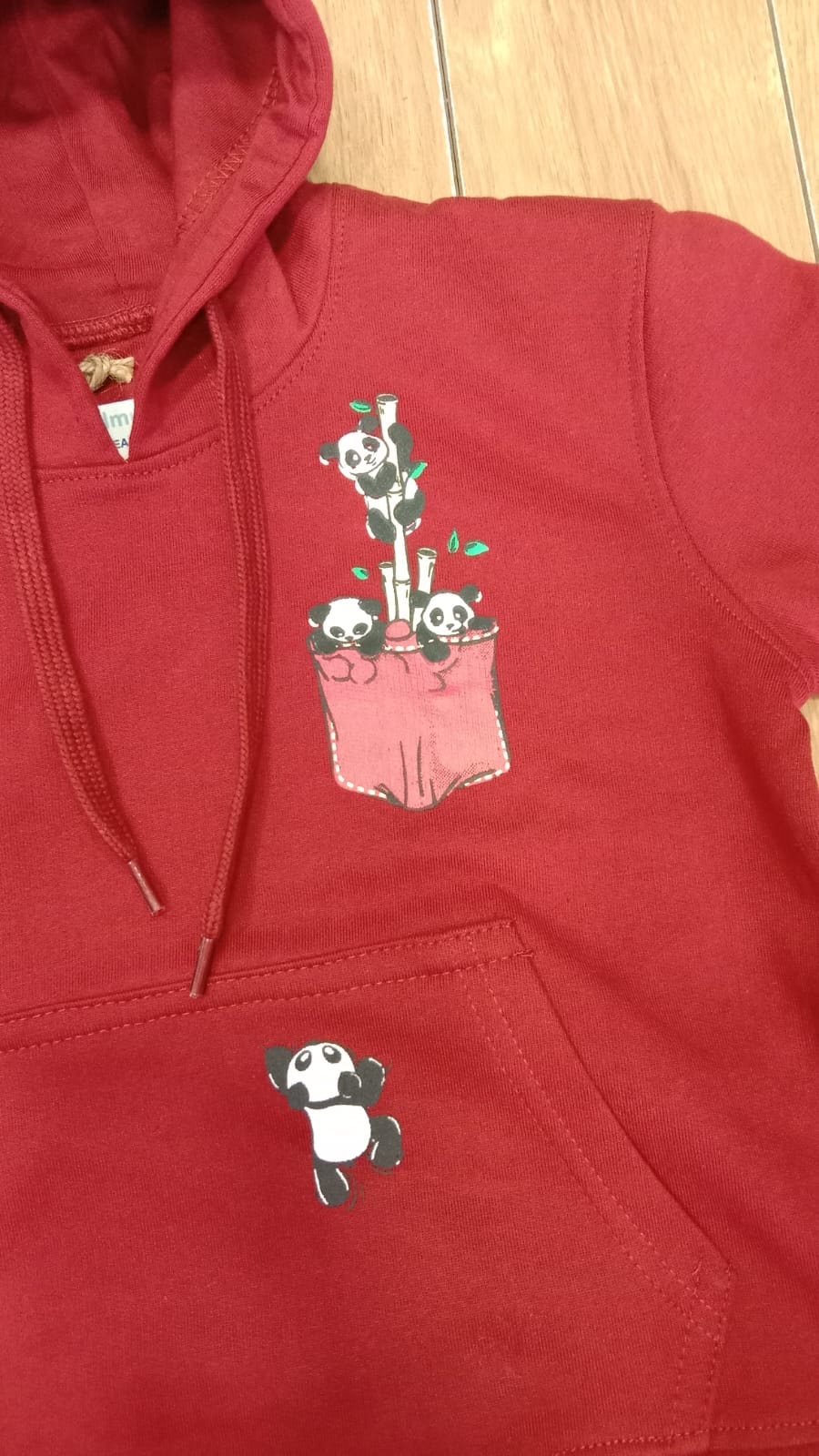 Close-up of the panda chest pocket print and drawcord hood