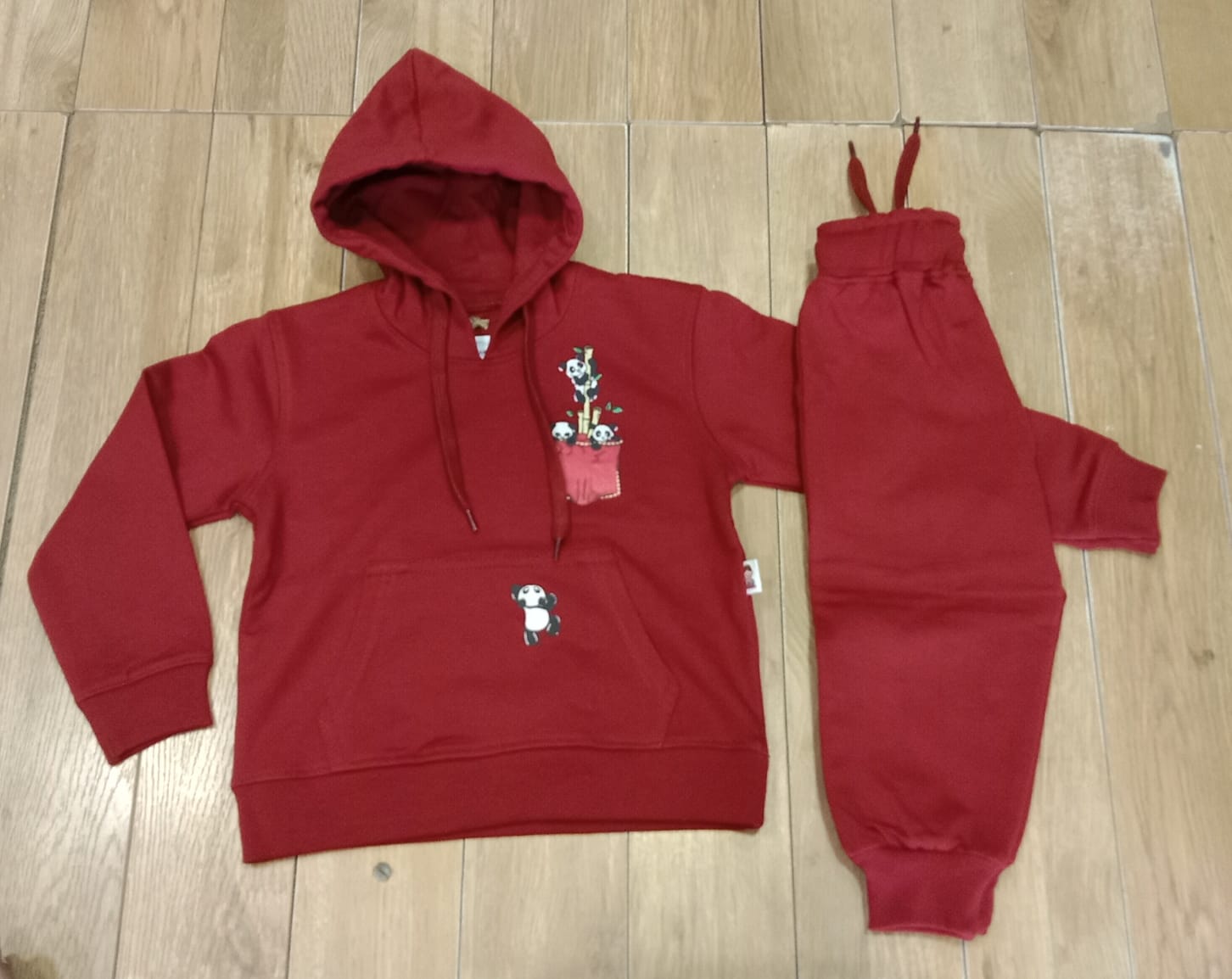 Red panda pocket pullover hoodie with matching joggers, laid flat